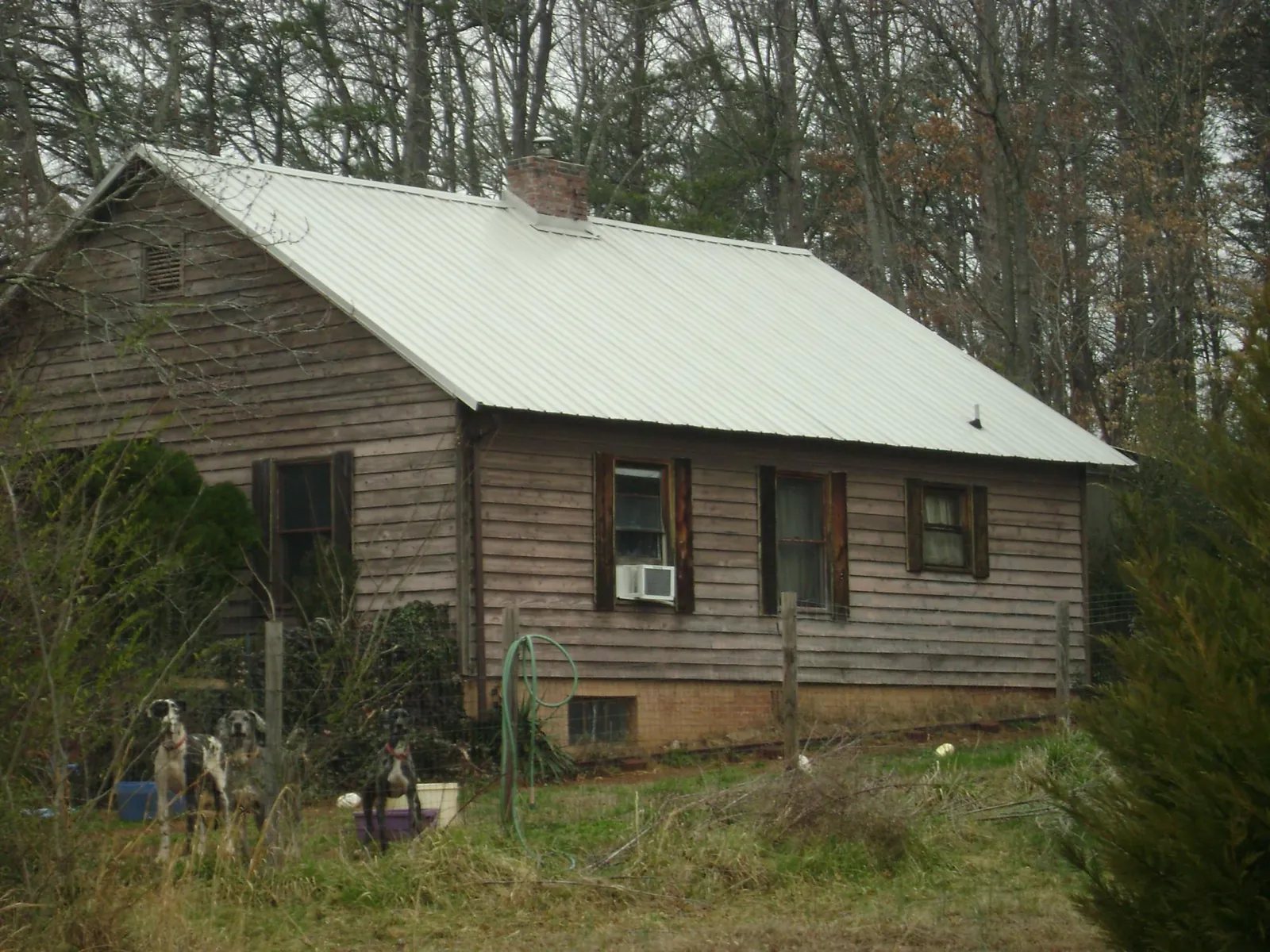 White metal roof on an old wood sided farmhouse, from a Metal Roof Installation job in Lawrence